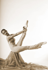 sports girl in a ballet hall in complex poze.balerina warming up, light tones picture. daylight falls on the blonde © georg01