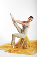 sports girl in a ballet hall in complex poze.balerina warming up, light tones picture. daylight falls on the blonde © georg01