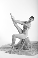 sports girl in a ballet hall in complex poze.balerina warming up, light tones picture. daylight falls on the blonde © georg01