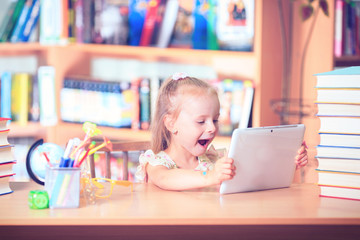 Portrait of an adorable baby girl wearing glasses on the table