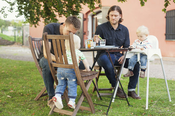 Fathers having breakfast with children at park