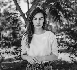 Outdoors portrait of beautiful young woman. In black and white toned.