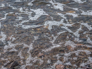 Waves at the seashore. Selective focus with shallow depth of field.