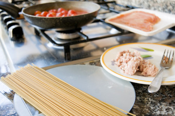 preparing wholemeal spaghetti with tomato sauce