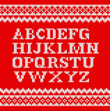 wei&szlig;es gestricktes Alphabet auf rot