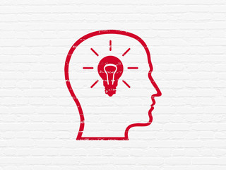 Business concept: Head With Lightbulb on wall background