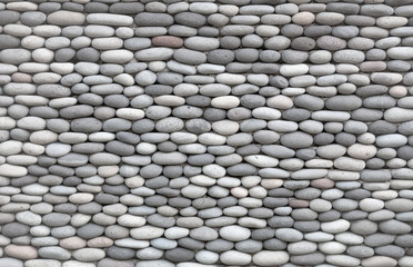 Background - wall decorated with smooth stones
