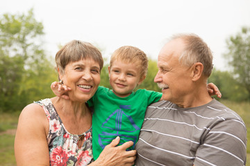 Fototapeta premium Grandparents having great fun with their grandchild
