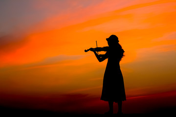 The silhouette of asian woman playing violin