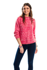 Woman in pink sweater smiling. Dark navy pants. Woolen pullover and stretch trousers. Fashionable spring outfit.