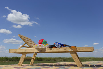 Chaise lounge by the pool .