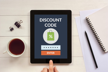 Discount code concept on tablet screen with office objects. All screen content is designed by me