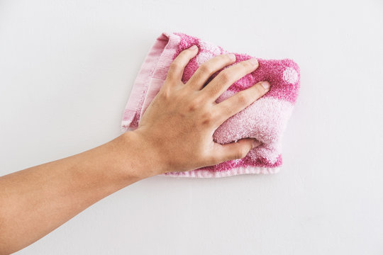 Hand cleaning white wall