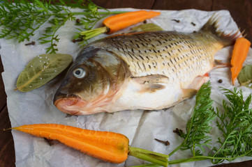 River fish - bream with spices on a wooden background.
