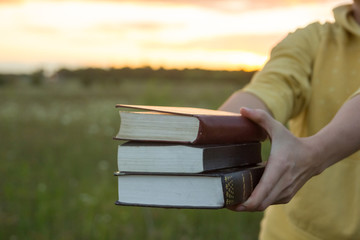 Female hands holding opened hardback book, diary with fanned pag