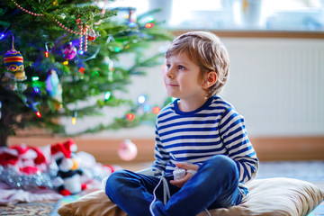 Little kid boy playing video game console on Christmas