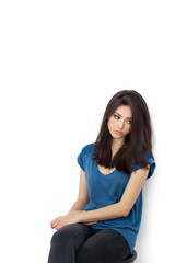 Young bored upset woman sitting on chair