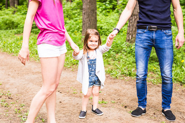 Fototapeta premium Daughter, parents were holding hands in the park