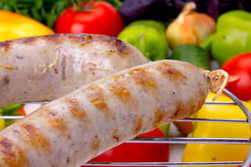 Grilled sausages with vegetables shot up close