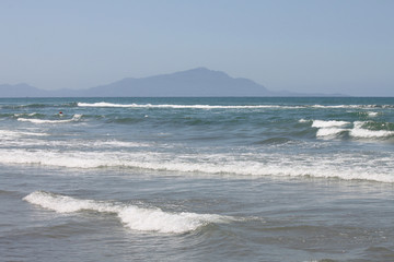 Mediterranean Sea with blue summer wave background. Beautiful water nature. Sea waves on beach. Blue sea and cloudless sky.