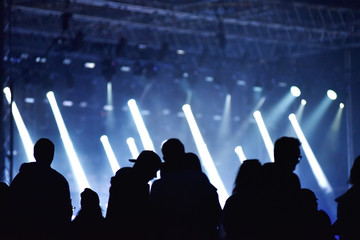 Stage lights. Concert scene with crowd in foreground