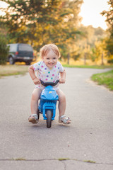 Active kid playing and cycling outdoors