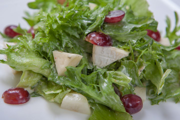 Fresh salad of lettuce with sweet sauce with pieces of fruit