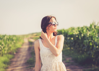 Portrait of young woman on a rural road. Retro look.