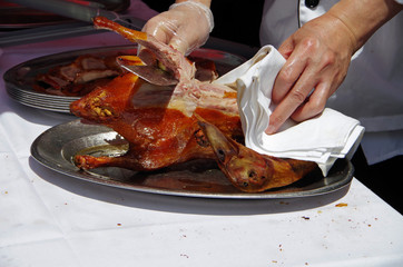 Traditional chief prepares roasted duck