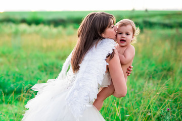 A young mother in the image of an angel embraces, protects your baby. Stylized fairy tale characters