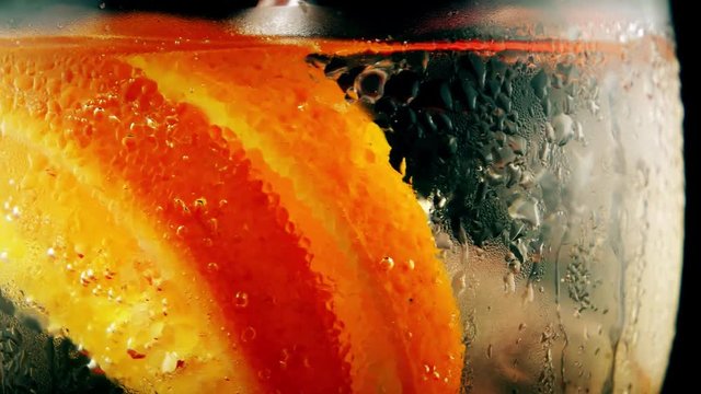 Fresh ice summer cocktail with orange, closeup