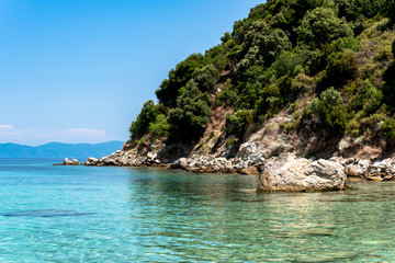 Fototapeta na wymiar Exotic blue sea lagoon at Greece, mount Athos in the background