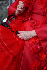 elegant lady with vintage style red dress and a black fan
