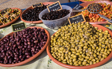 Different marinated olives on provencal street market in Provence, France