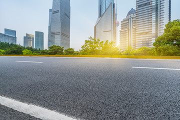 clean asphalt road with city skyline background,china.