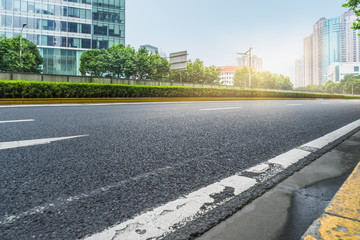 clean asphalt road with city skyline background,china.