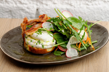 Healthy Brunch Breakfast with Wholemeal Bread Toast and Poached Egg with Green Salad