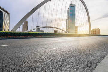 clean asphalt road with city skyline background,china.