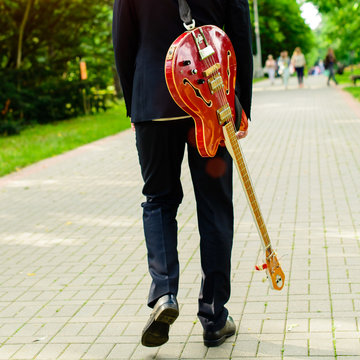 man with a bass guitar outdoor