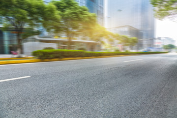clean asphalt road with city skyline background,china.