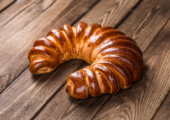 Tasty croissants with spikelets on grey wooden background