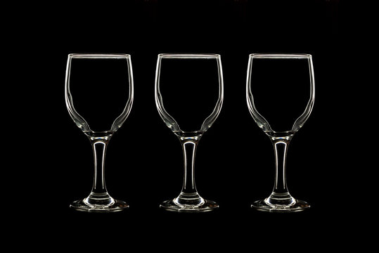 Empty three wine glass on black background