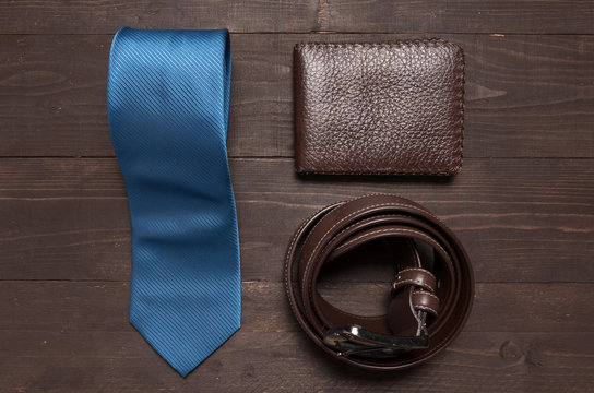 Elegant set: blue tie, brown leather belt, brown wallet, on the
