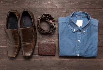 elegant set: brown men's shoes, brown leather belt, blue shirt,