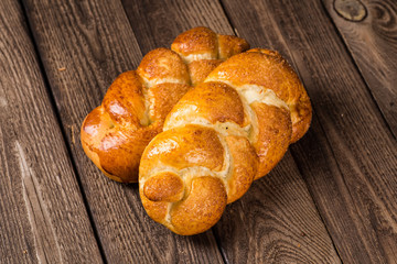 Assortment of baked bread on wooden table background