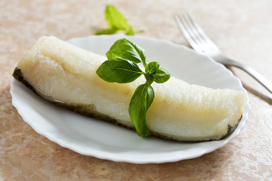 baked cod in a white plate