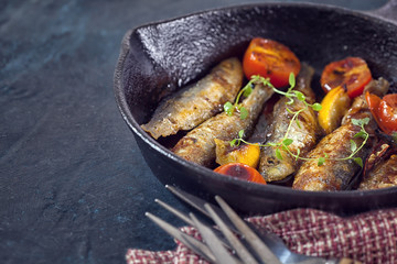 Grilled fish in cast iron skillet with copy space