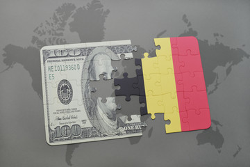 puzzle with the national flag of belgium and dollar banknote on a world map background.