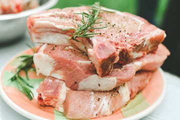 Raw beef with spices at outdoor. Raw fresh meat rib eye steak and seasoning