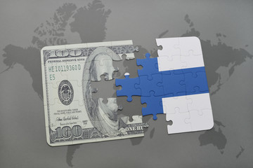 puzzle with the national flag of finland and dollar banknote on a world map background.